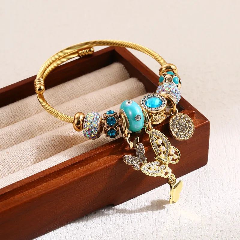 Βραχιόλι χρυσό ατσάλι με πεταλούδα και charms-BR488